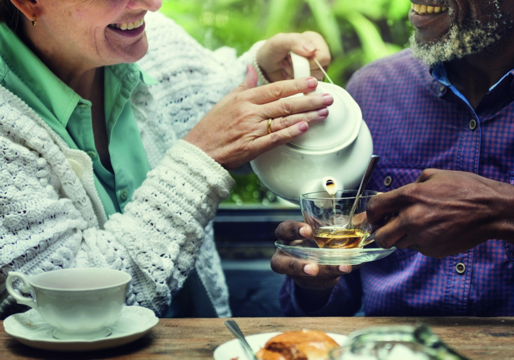 Two friends sharing a pot of tea in Derby