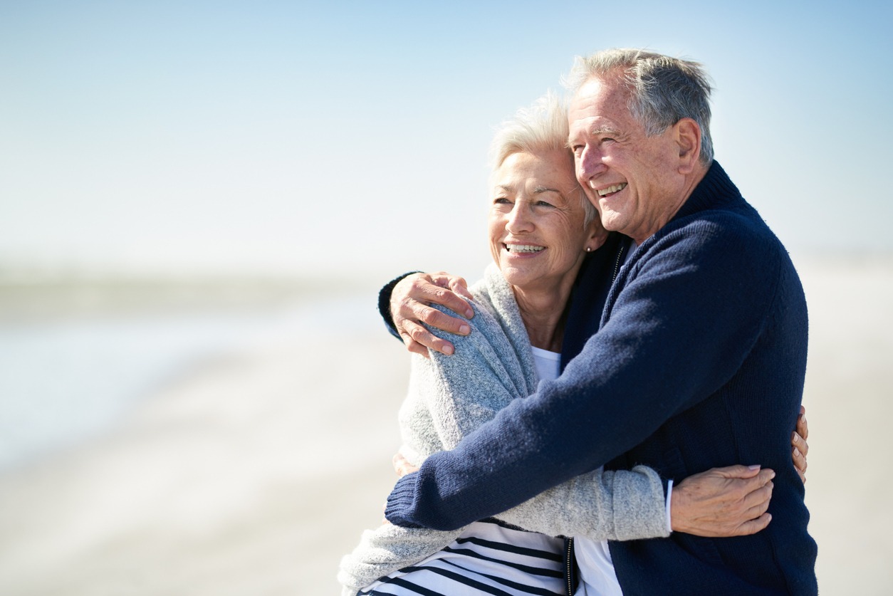 property blogs​ image of couple on the beach hugging